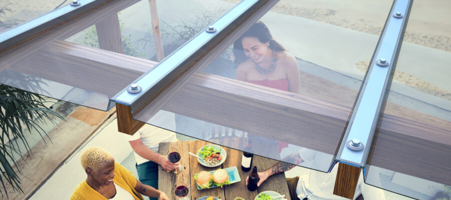 Close up of Clear EZ Glaze™ Polycarbonate system installed on a pergola above a Group Of People Dining Close up of Clear EZ Glaze™ Polycarbonate system installed on a pergola above a Group Of People Dining